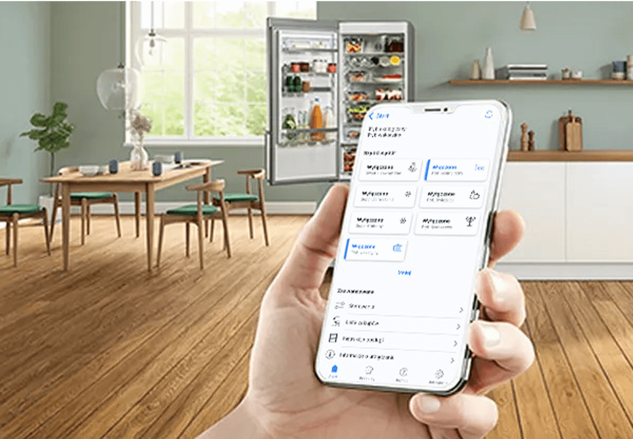Ręka ze smartfonem z włączoną aplikacją Home Connect umożliwiającą zdalne sterowanie temperaturą w lodówce Bosch. W tle kuchnia i otwarta lodówka