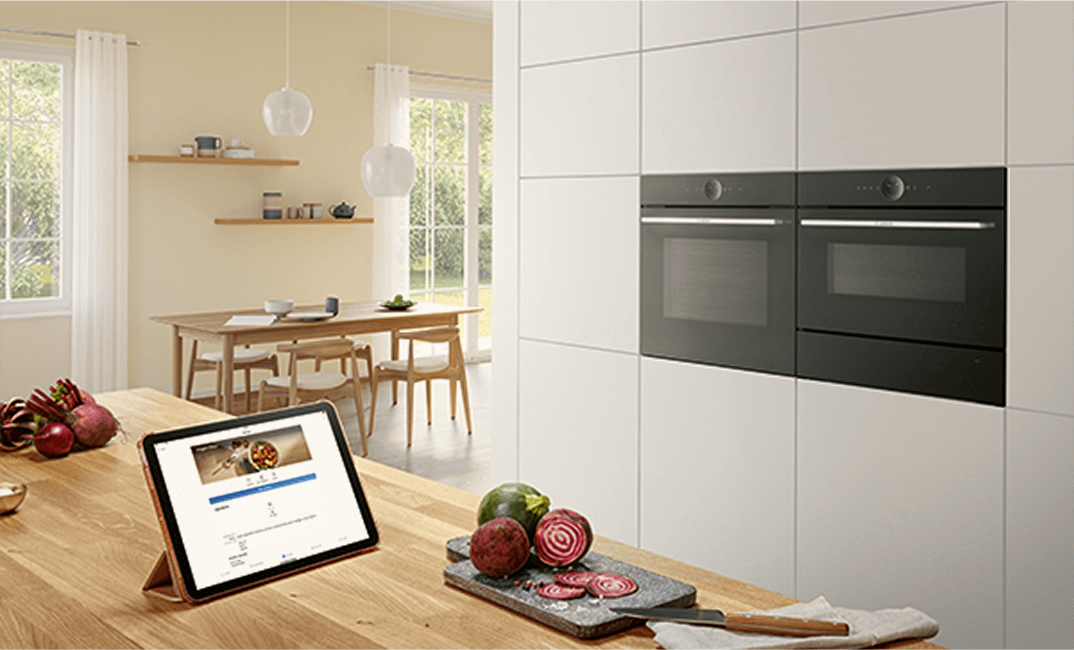 Piekarnik Bosch w nowoczesnej kuchni, sterowany przez tablet. Na tablecie włączony jest wybrany przepis